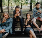 Teenagers in the public park using smartphones