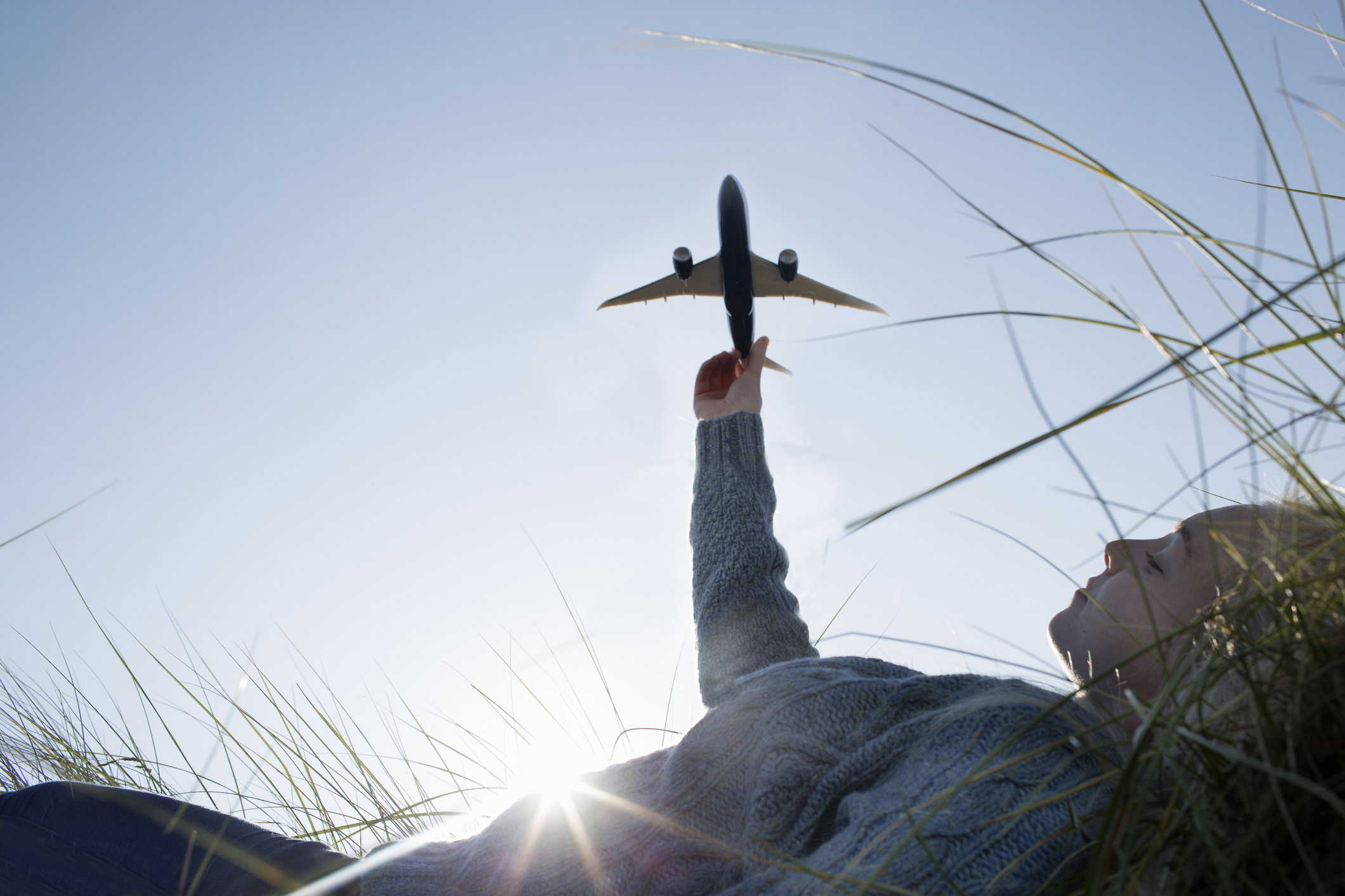 Teenage girl holding model aeroplane