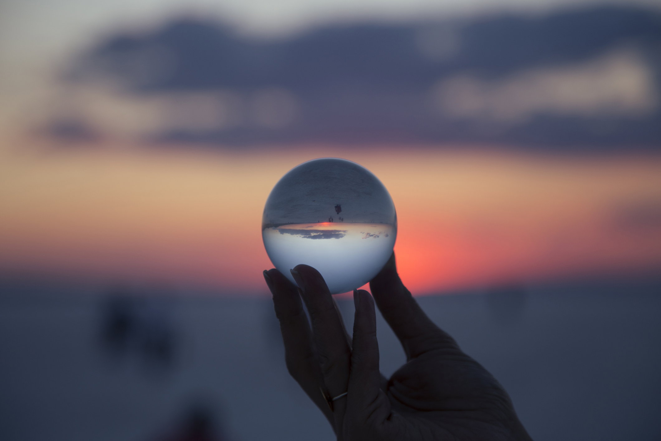 woman's hand with crystal ball Sunset