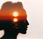 Conceptual double exposure. Sunrise in the woman head.