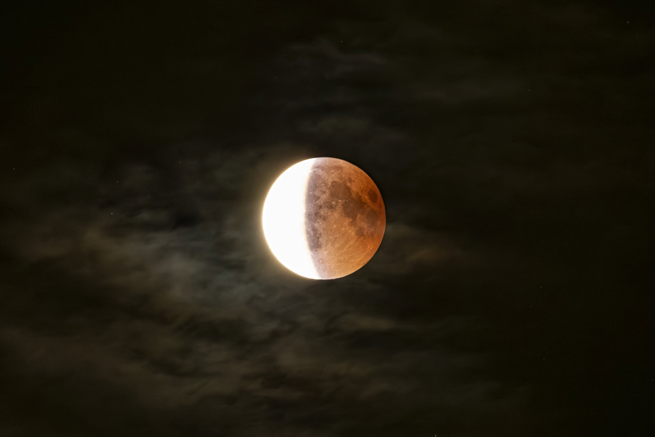 Lunar eclipse close-up in a cloudy night