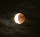 Lunar eclipse close-up in a cloudy night