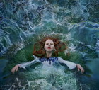 Red haired woman falling into water
