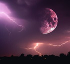 Halloween night sky with clouds and flashes of lightning and an emerging bloody red full moon closeup at the time of the Sabbath