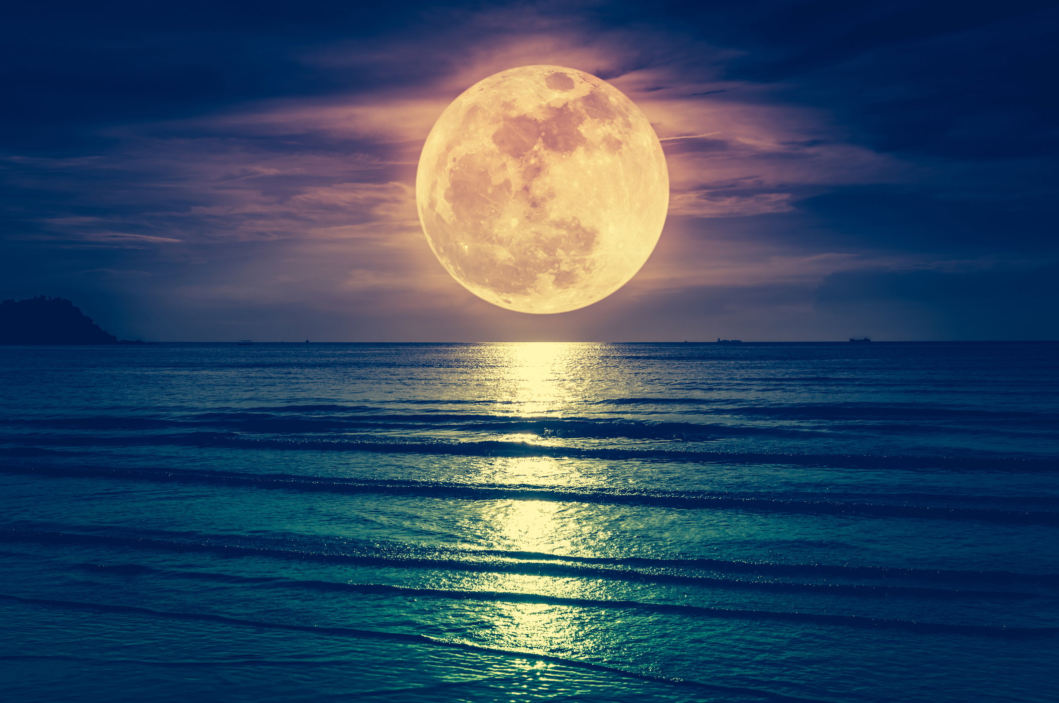 Super moon. Colorful sky with cloud and bright full moon over seascape.