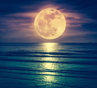 Super moon. Colorful sky with cloud and bright full moon over seascape.