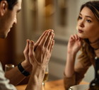 Close-up of man begging his girlfriend for forgiveness.