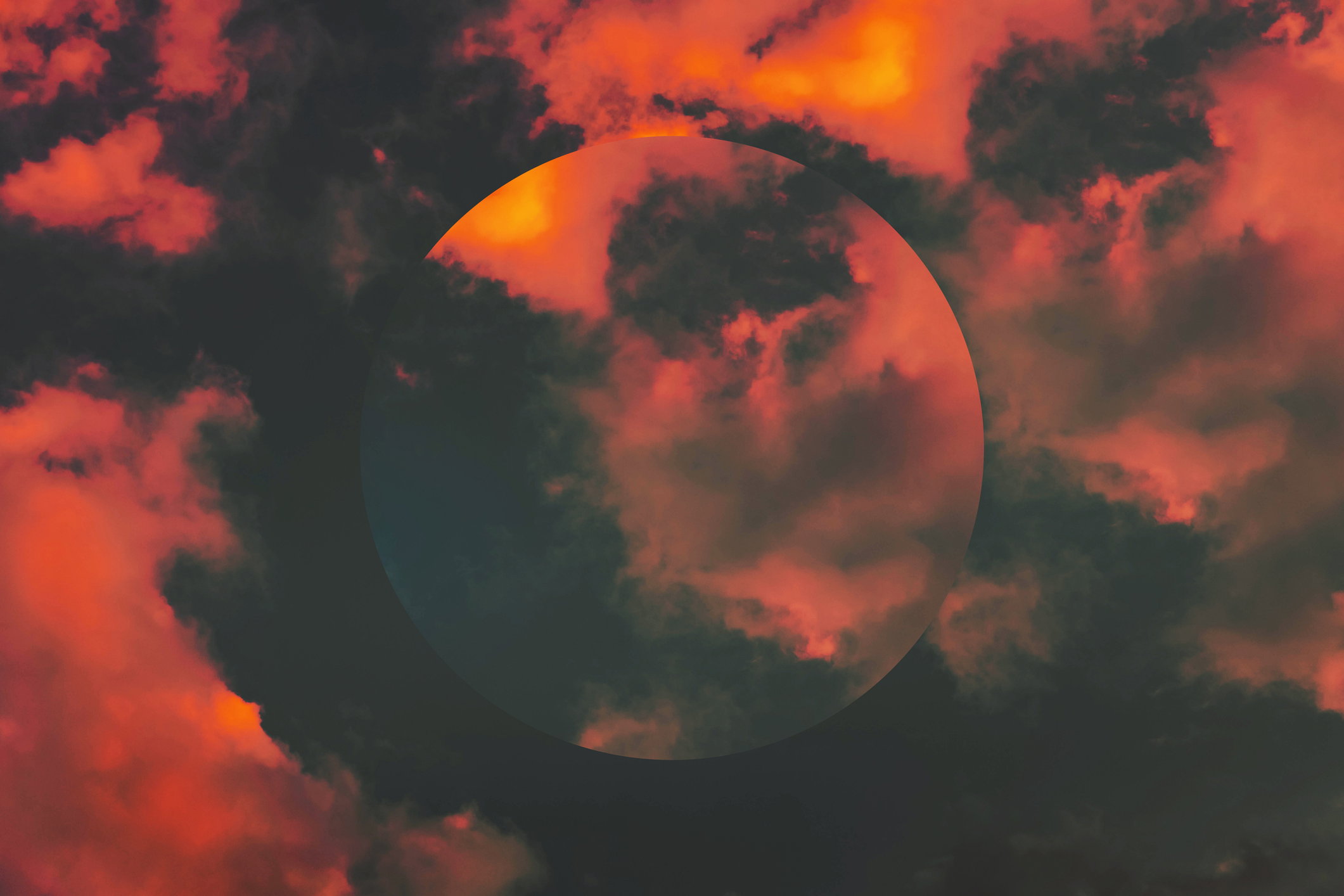 Creative picture of dramatic sunset sky with circle mirror reflection.