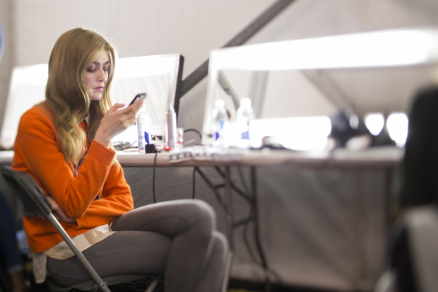 Modelki z telefonami na backstage'u pokazów mody