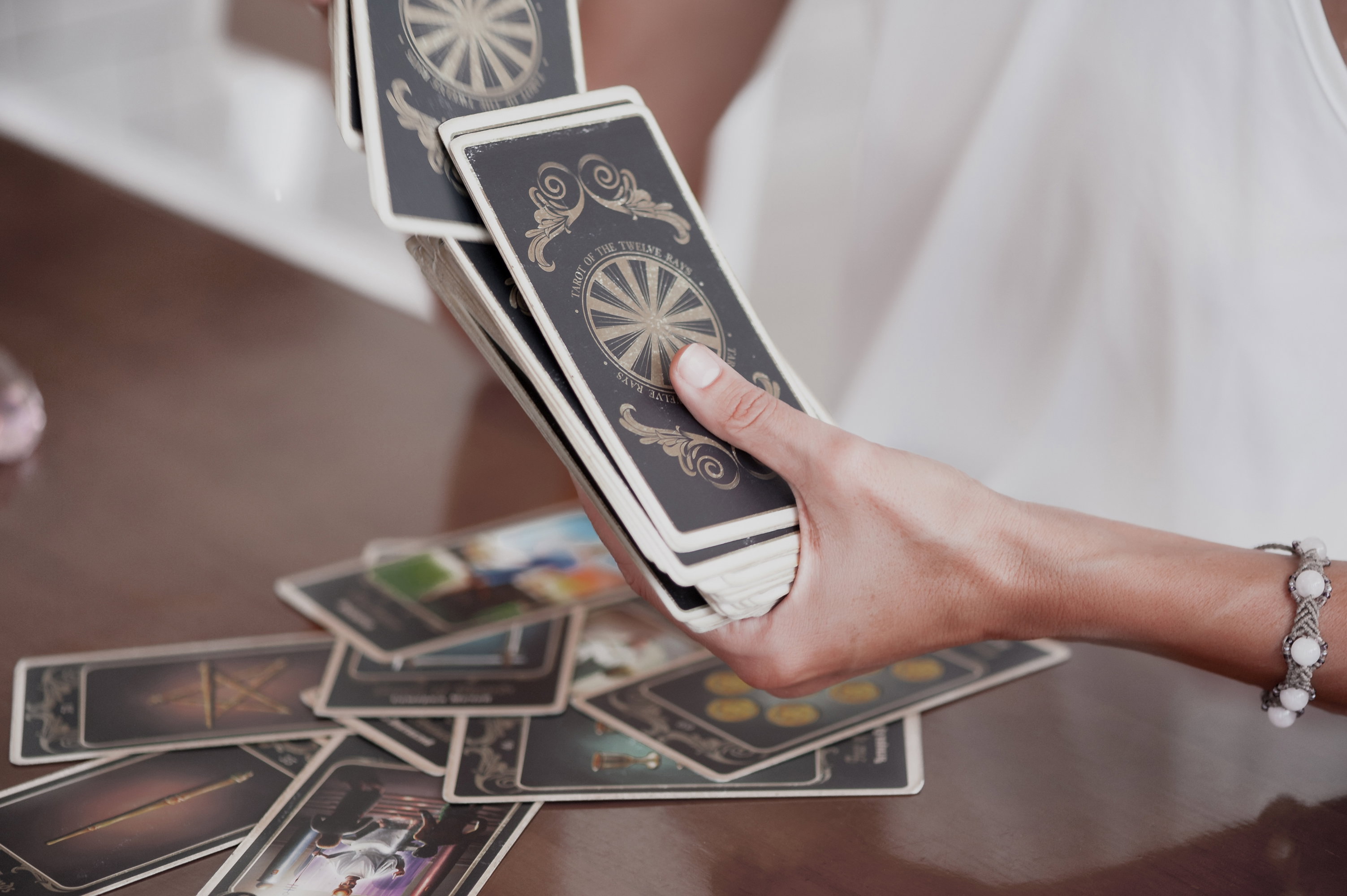Woman is reading Tarot cards in cafe