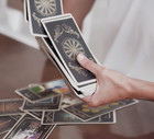 Woman is reading Tarot cards in cafe