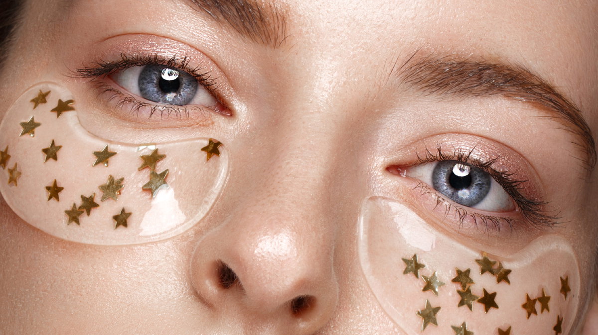 Beautiful fresh girl with cosmetic patches under eyes, perfect s