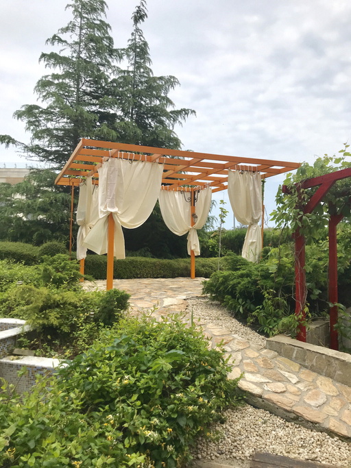 a tent in a beautiful garden in the summer