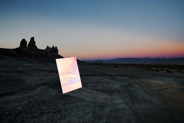 Poetic picture of mirror reflecting sunset sky in the middle of desert in California.