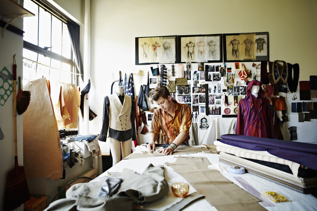 Designer in studio measuring pant width