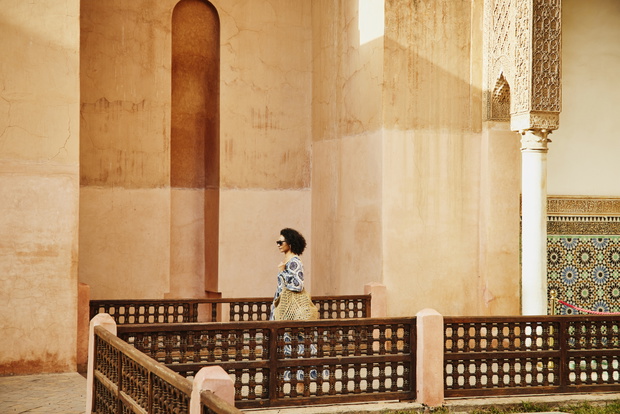 Wide shot solo female tourist visiting historical site in Morocco