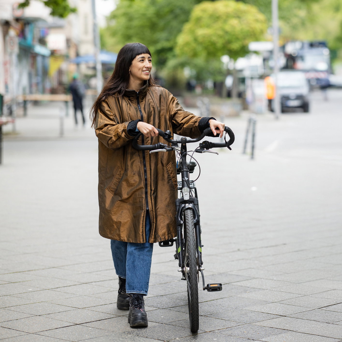 Friends walking with bicycles on street