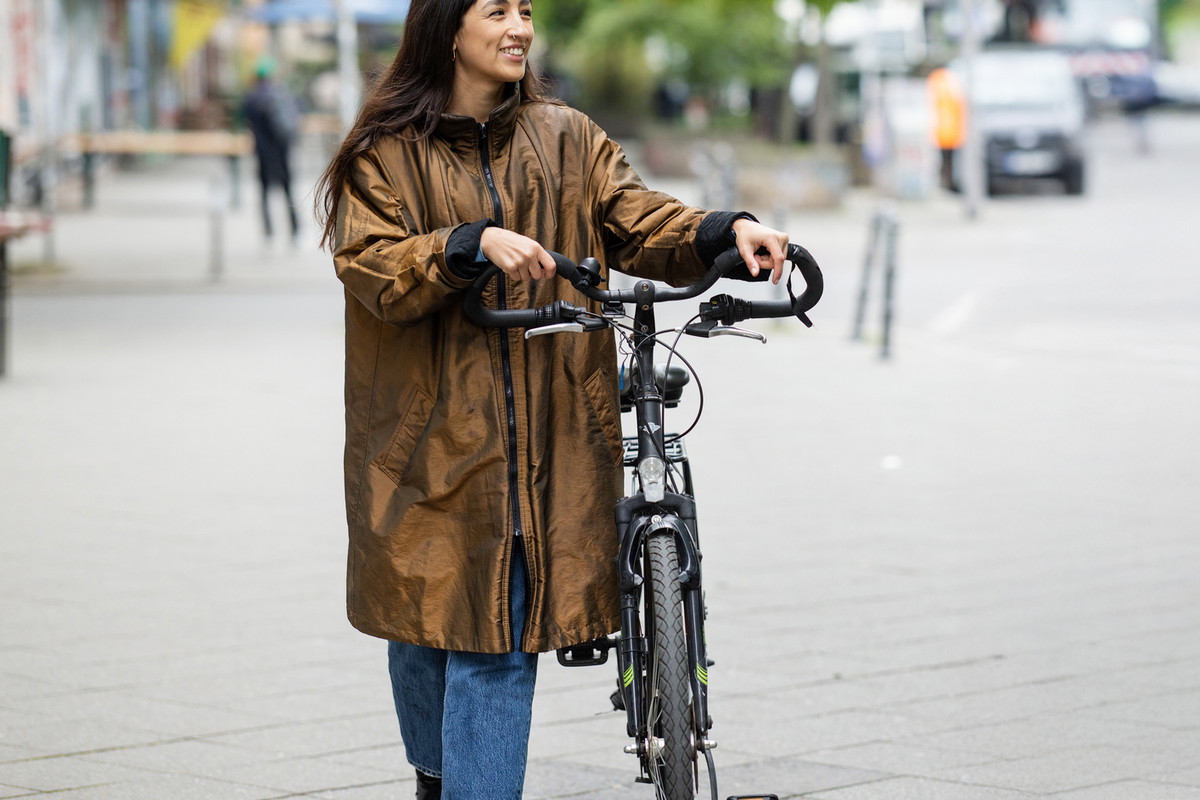 Friends walking with bicycles on street