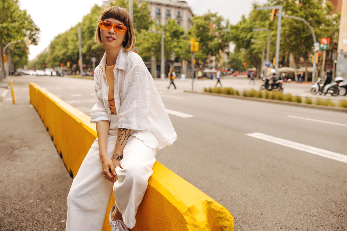 Modern young caucasian girl posing looking at camera outdoors.