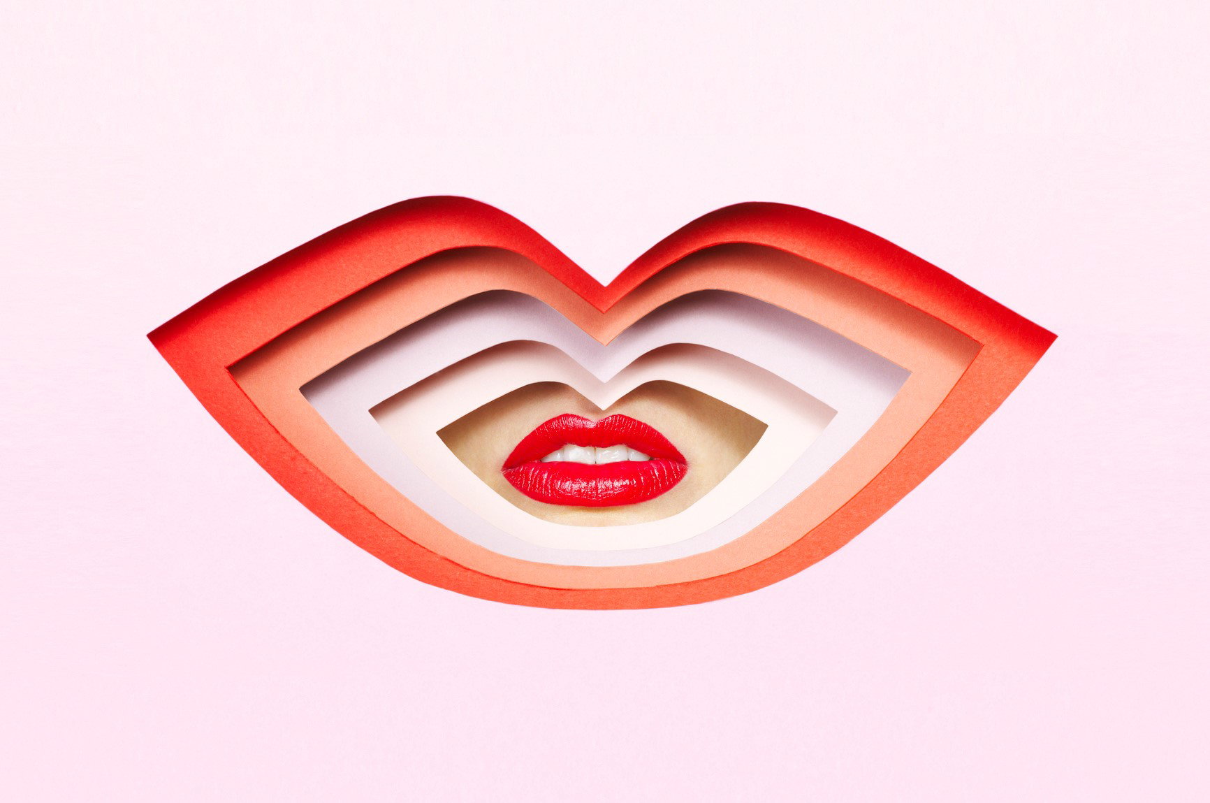 Lips through cardboard cutout