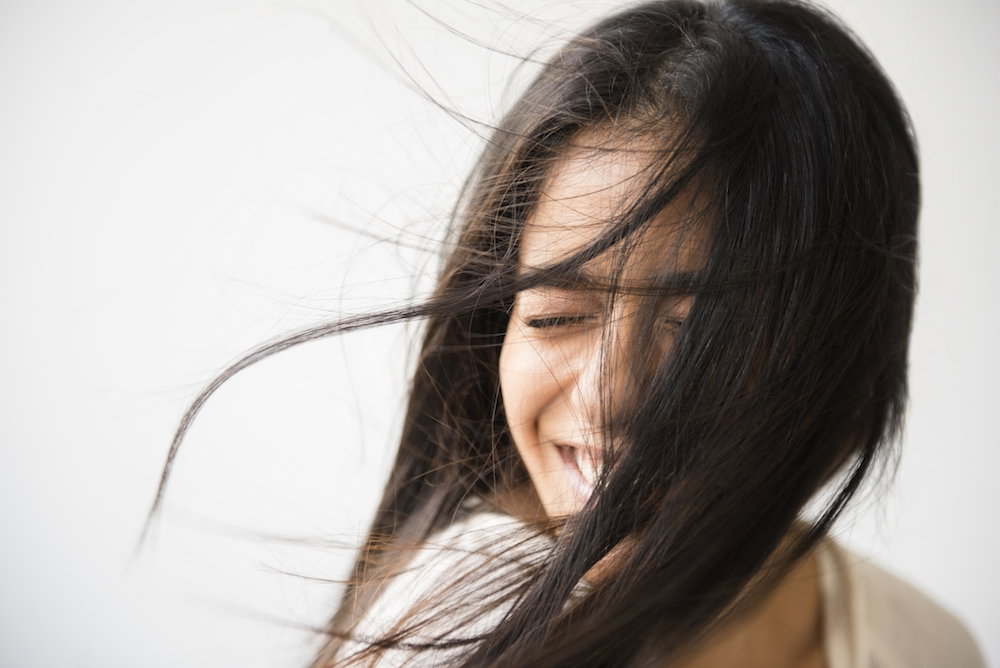 Hair of Indian woman blowing in wind