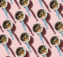 Top view of pan full of various pills and tablets on the blue background