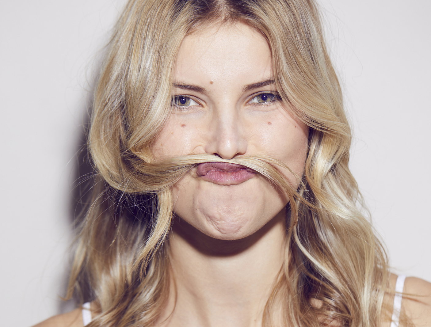 Portrait of young woman pulling funny face