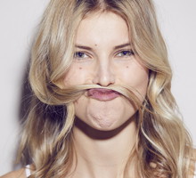 Portrait of young woman pulling funny face