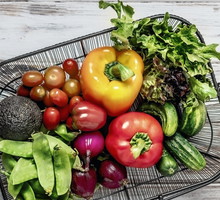 A basket of fresh fruits and vegetables on white background