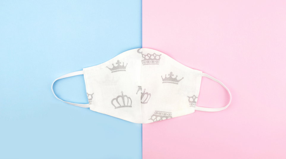 Cotton reusable mask on pink and blue background.