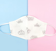 Cotton reusable mask on pink and blue background.
