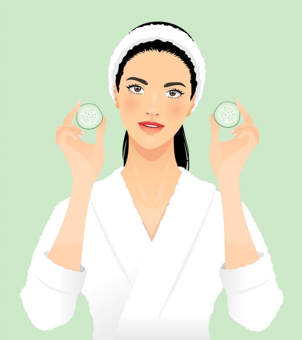 Young woman with cucumber slices