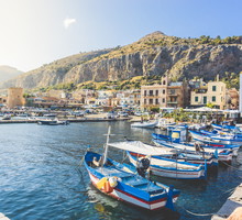 Boats Moored In Harbor Against Buildings In City