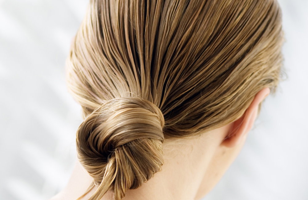Young woman with wet hair, view from the back, close up (studio)