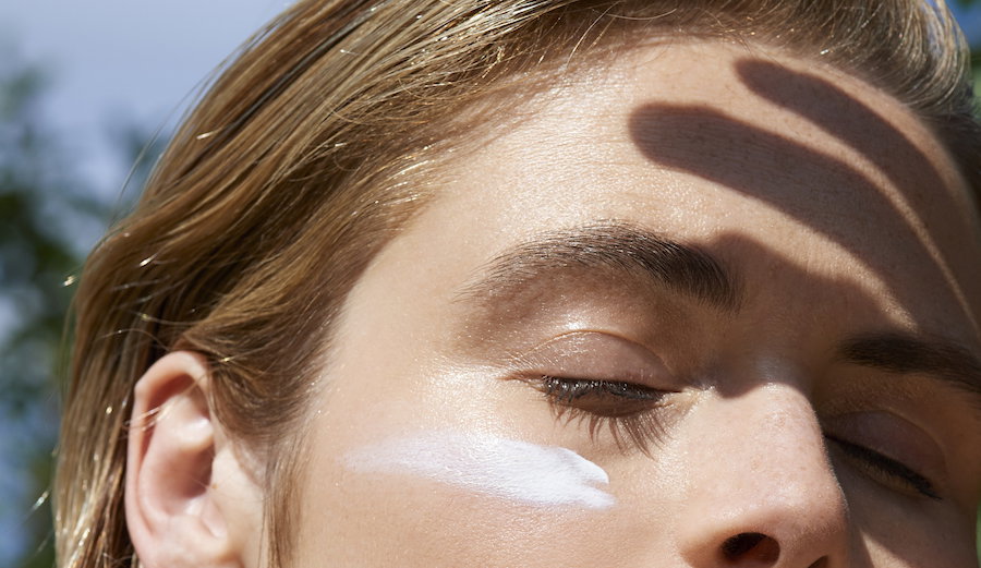 Woman protecting face from the sun