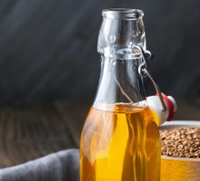 Flaxseed oil in a glass bottle, decorated with whole seeds with copy space