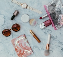 Top view of set female accessories on marble pink flat lay