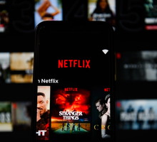 In this photo illustration a Netflix logo displayed on a