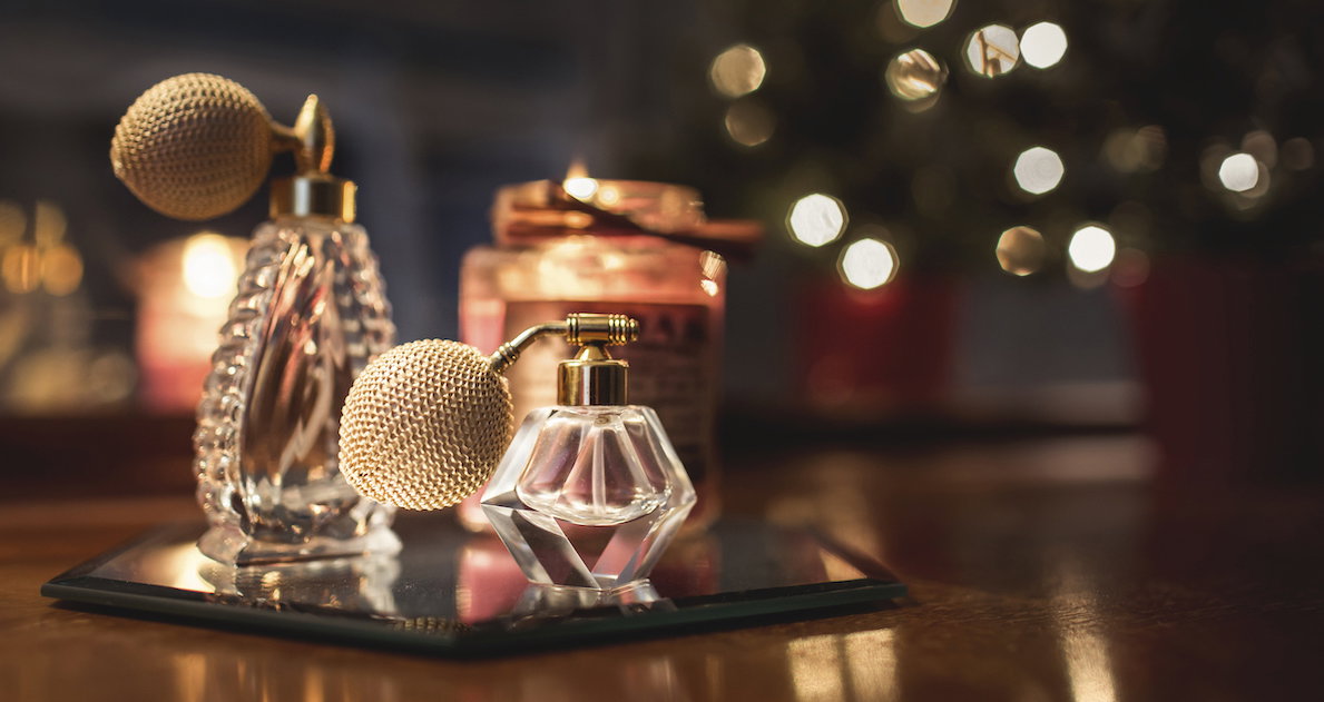 Close-up of perfume sprayers on wooden table