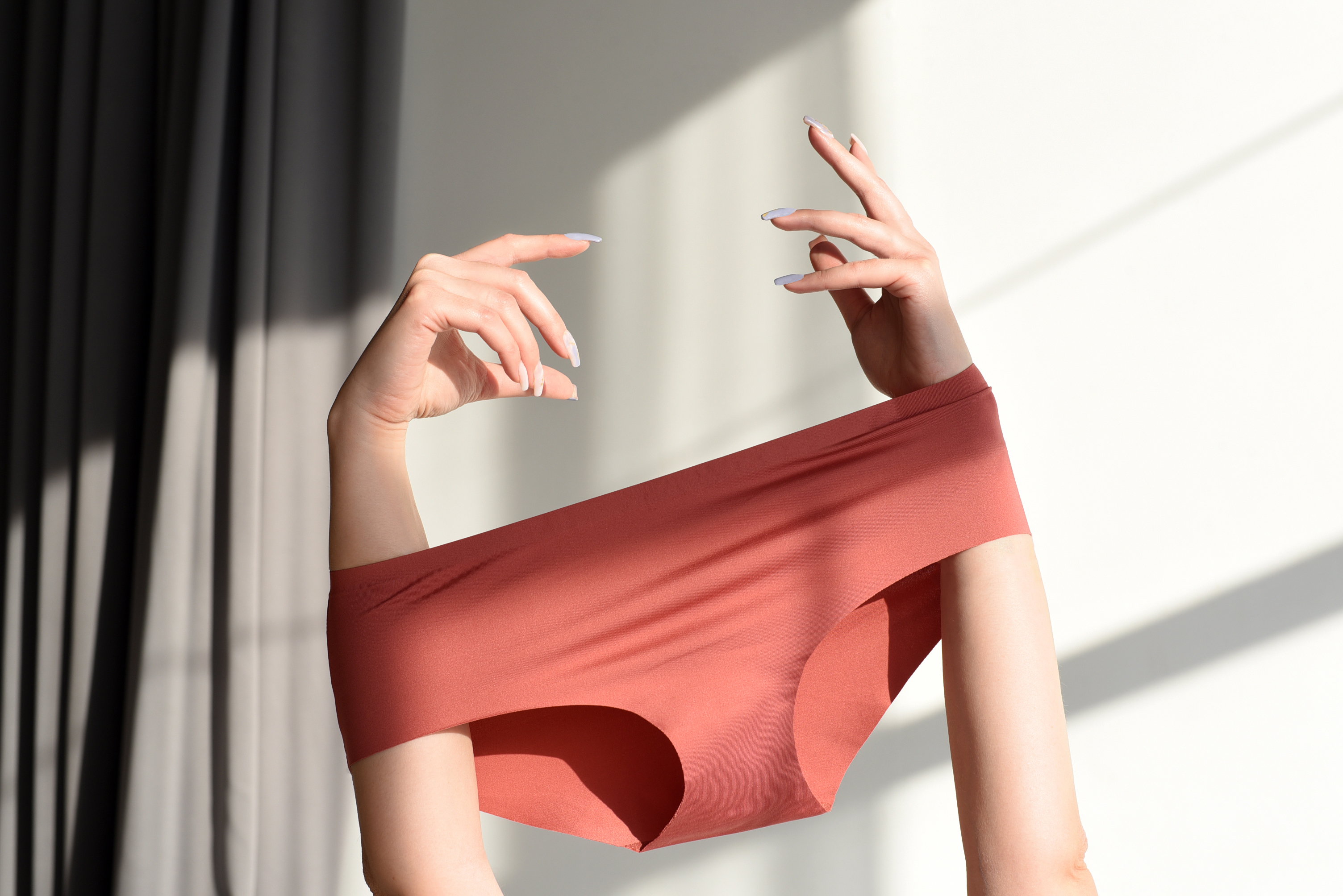 Seamless female panties in the hands of the girl.