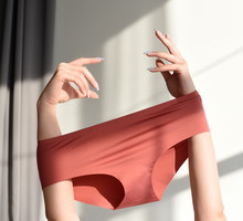 Seamless female panties in the hands of the girl.