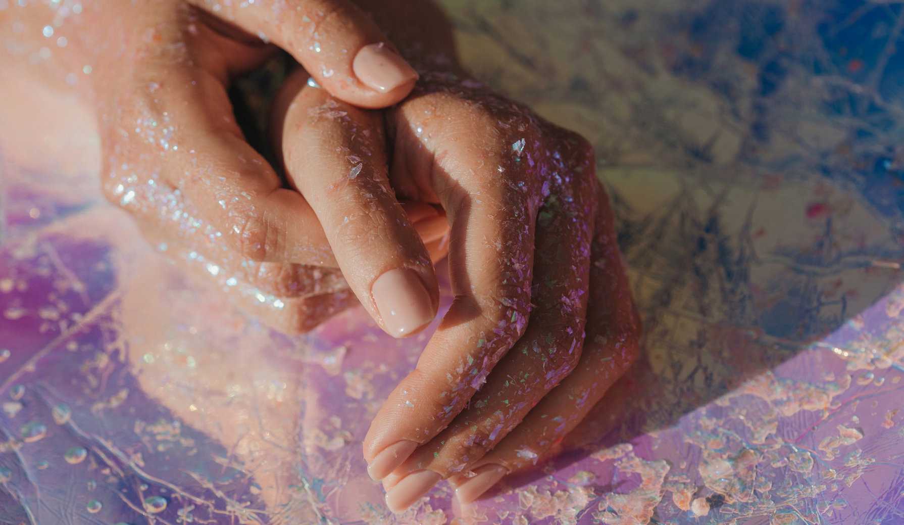 Human hands covered in glitter