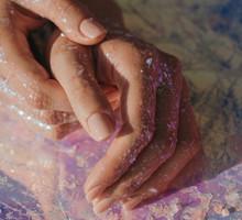 Human hands covered in glitter