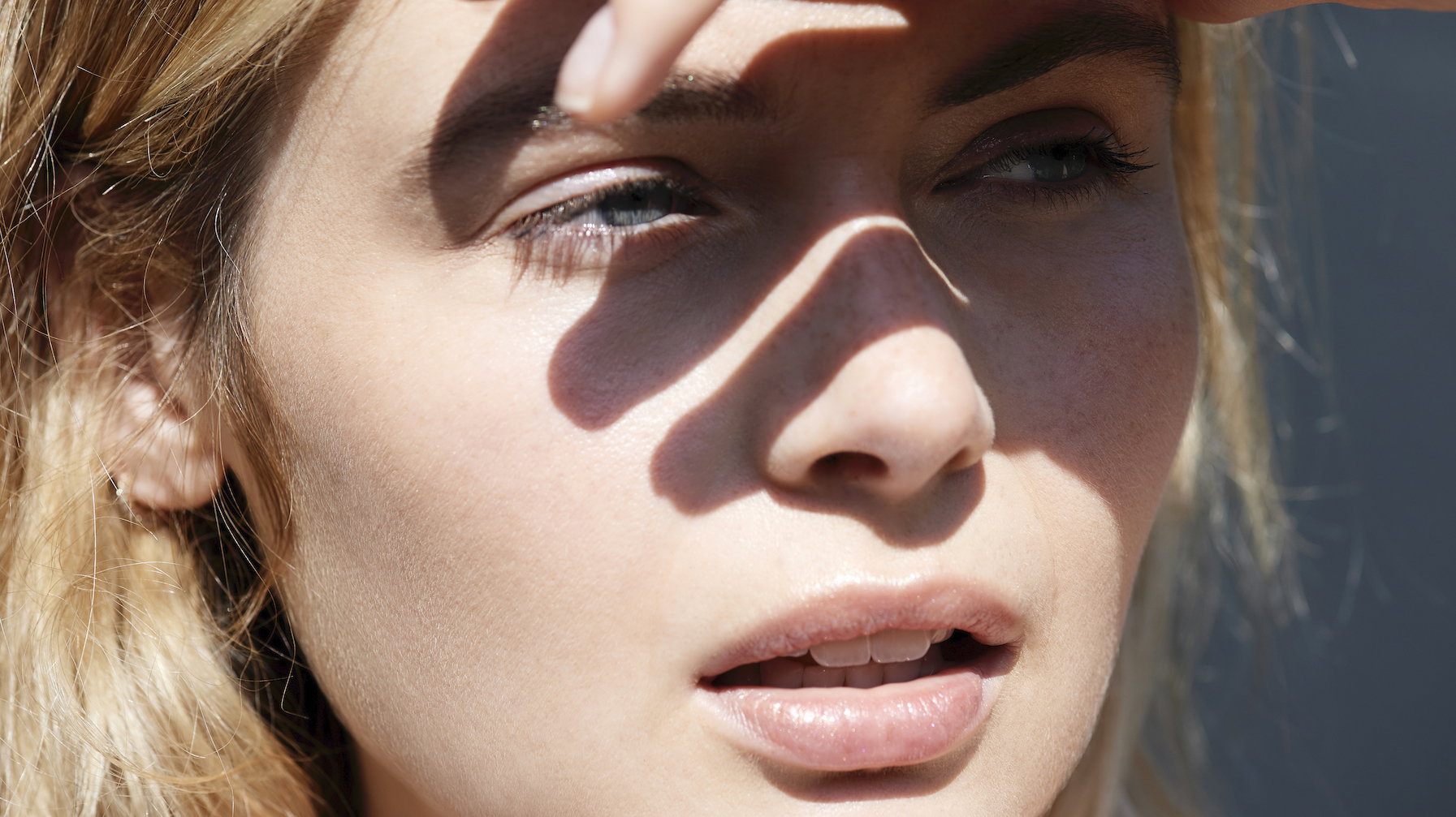 Woman shielding eyes from sun