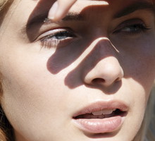 Woman shielding eyes from sun