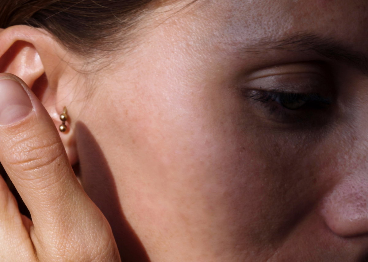 Close Up Of A Woman Ear With Multiple Earrings