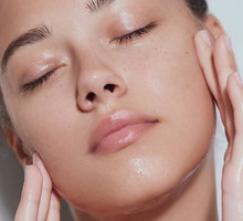 Young beautiful woman with clean fresh skin with splash of water - white background