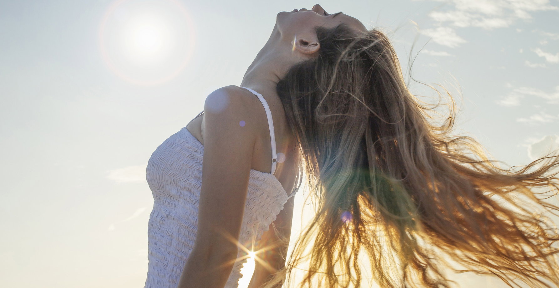 Caucasian woman tossing her hair outdoors