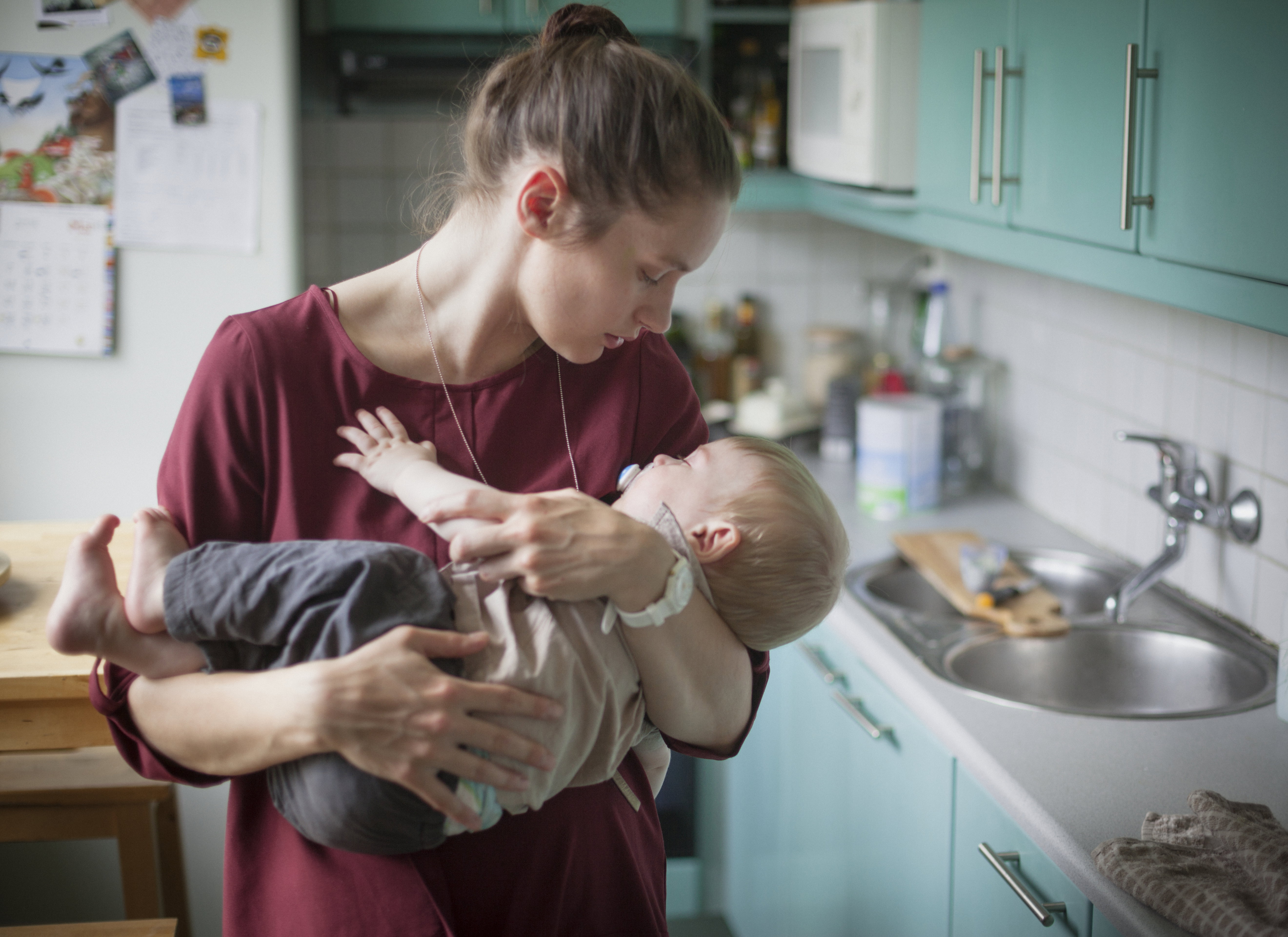 Mother embracing son (2-3) in kitchen