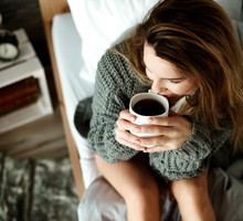 Woman Holding Coffee Cup At Home